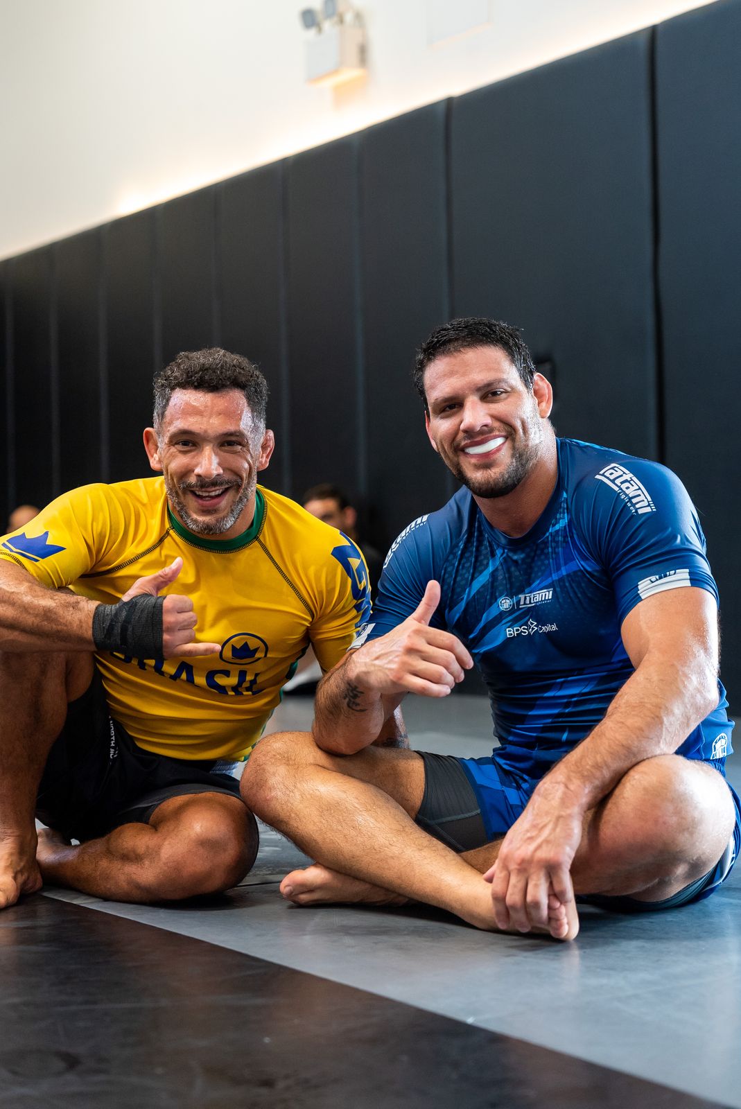 Two athletes sharing a laugh at the open mat in Dubai