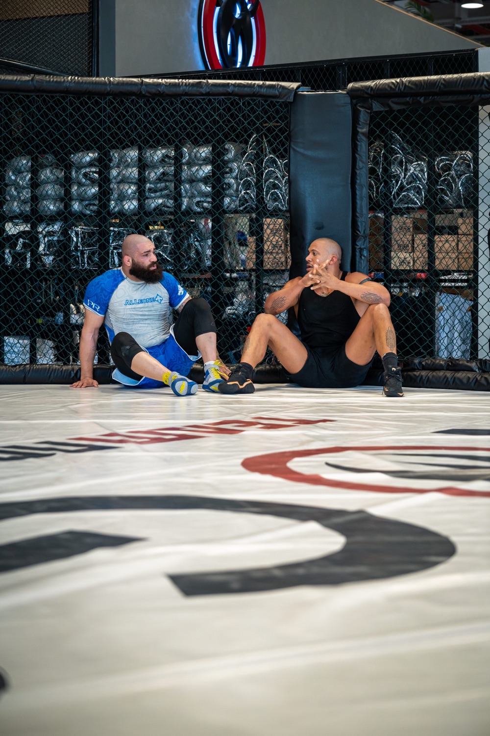 Fighters resting cage-side between rounds